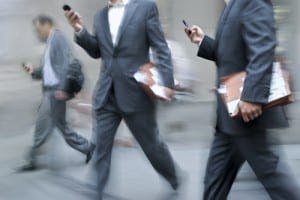men in suits on their mobile phones