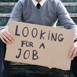 Man holding up a sign reading "Looking for a job"